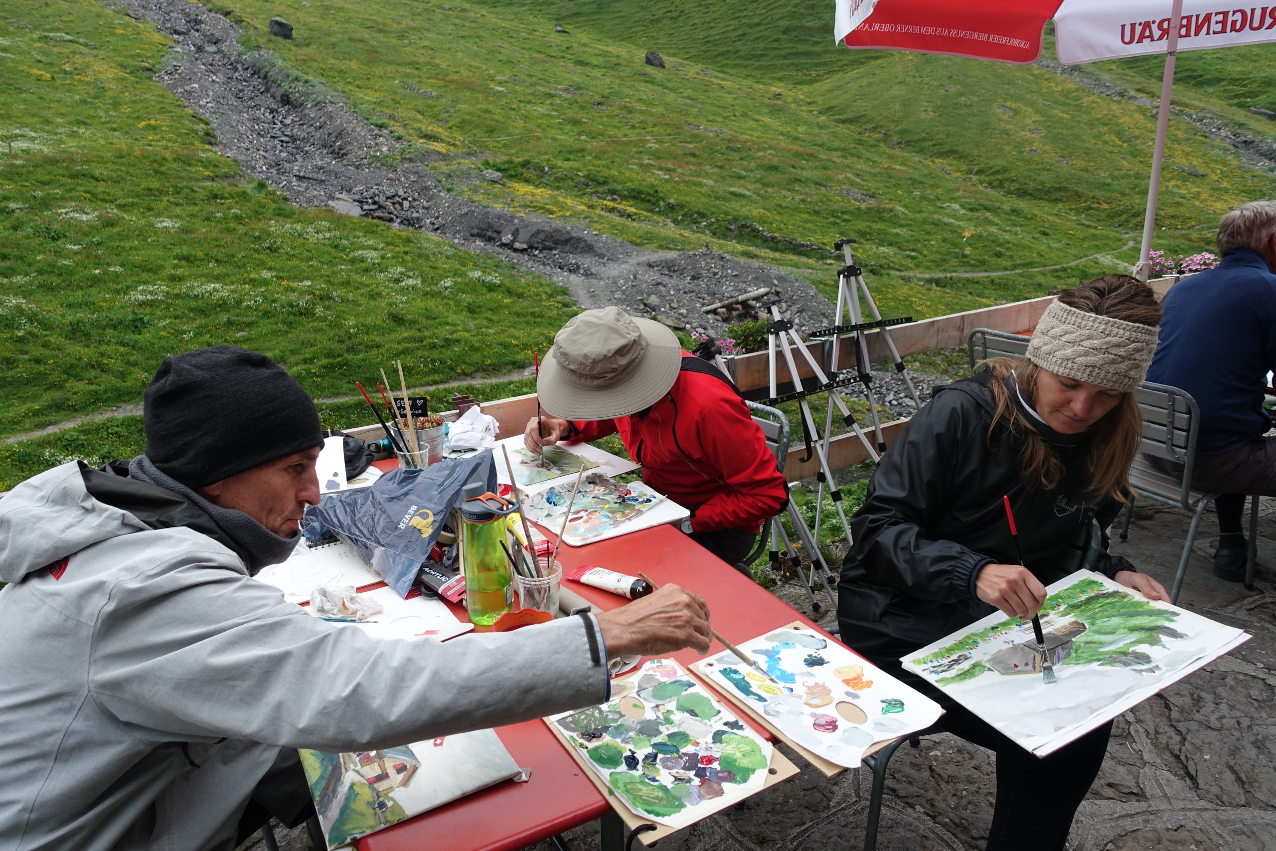 Schilderen in de bergen, zittend op de grond, op een terras, in een berghut. Bij een schildervakantie is een beetje flexibiliteit wel handig.
